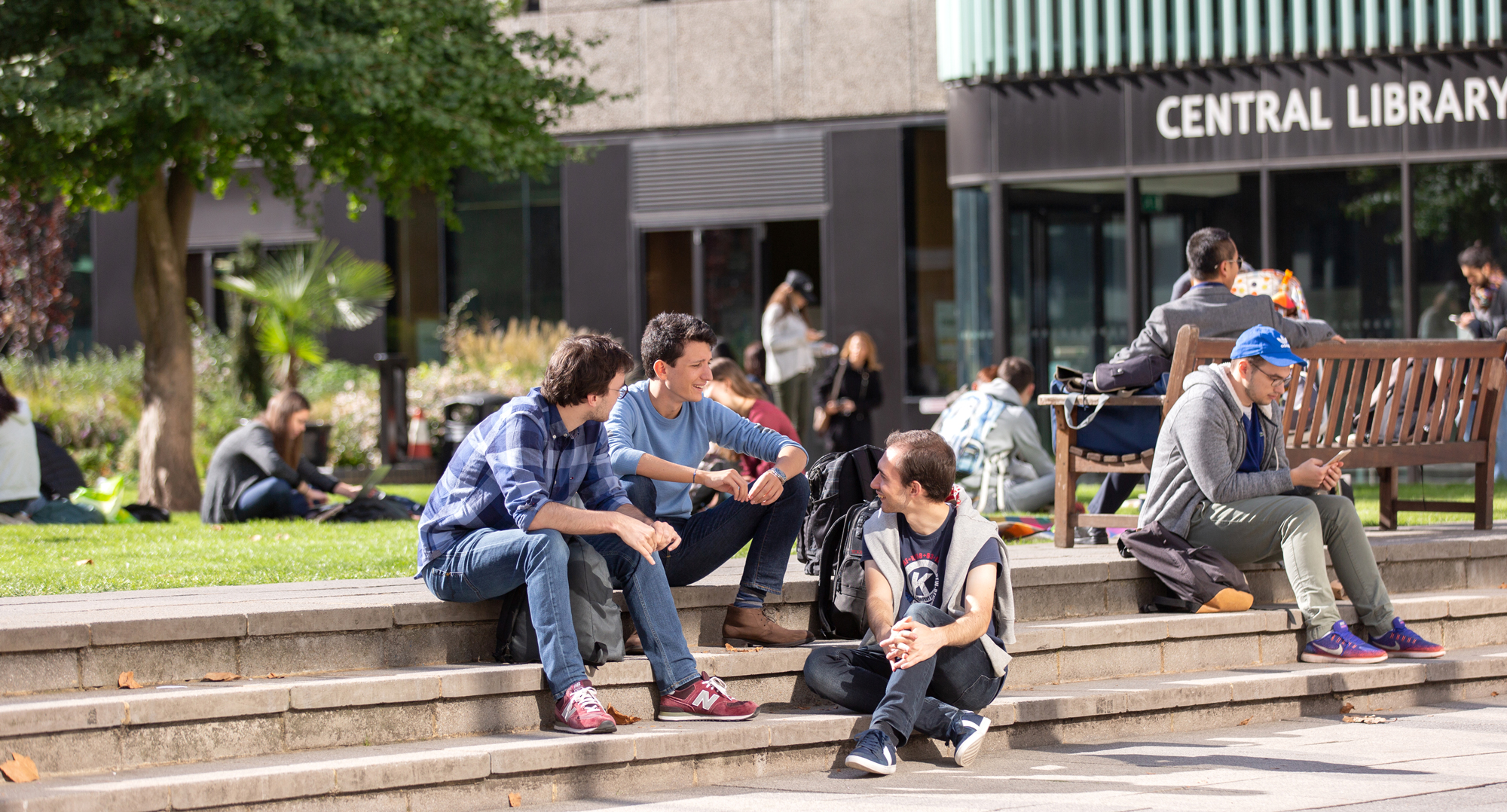 students sitting outside of imperial college london campus