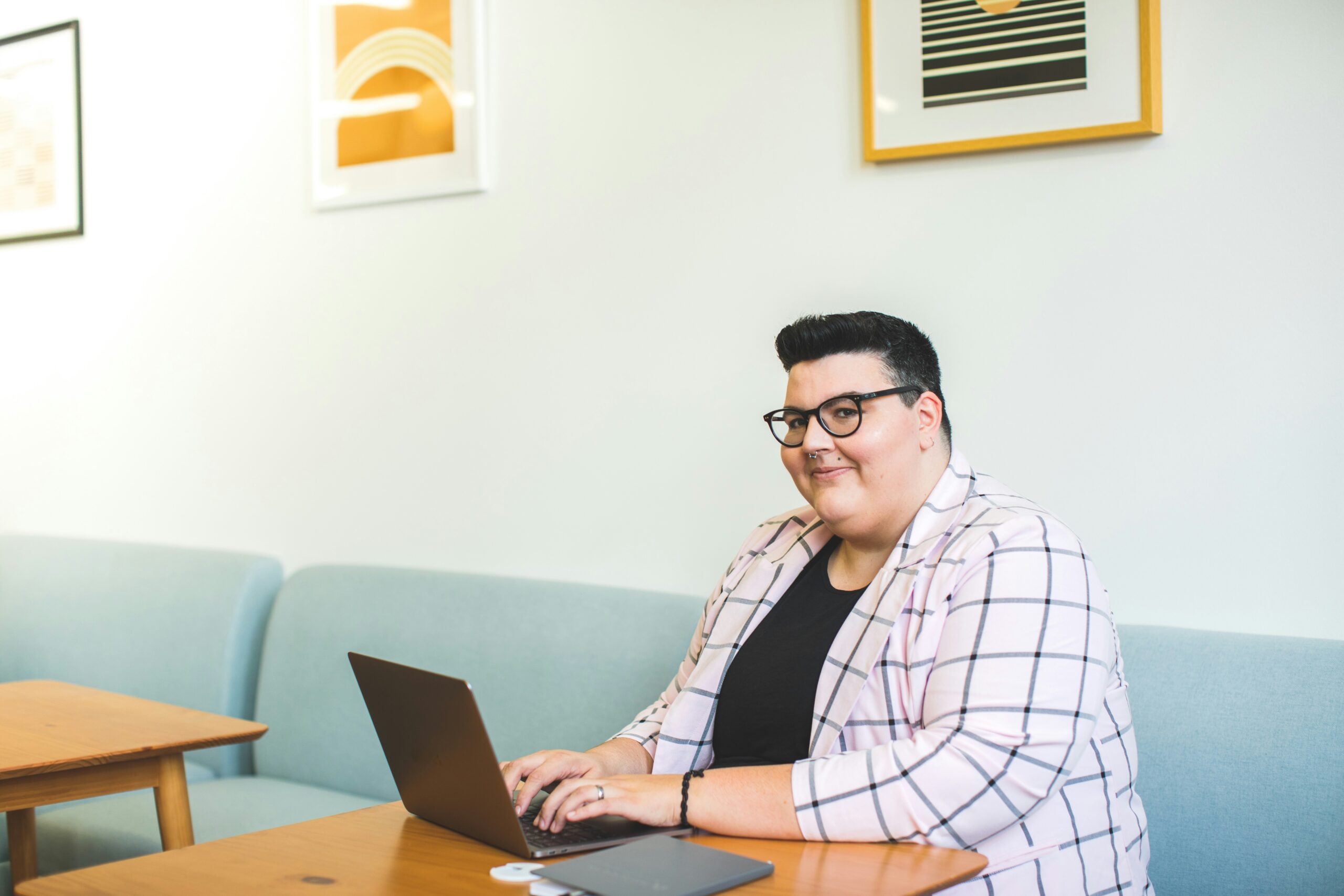 Plus size woman on her computer looking to camera