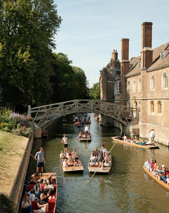 Cambridge river with boats and bridge.